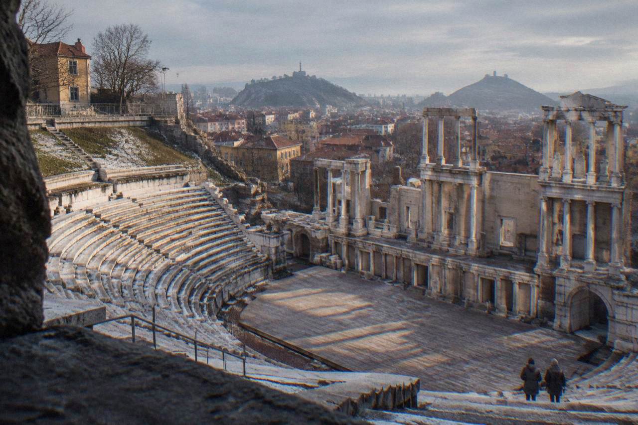 The Ancient Theatre of Philippopolis under a grey winter sky, its marble rows empty of visitors