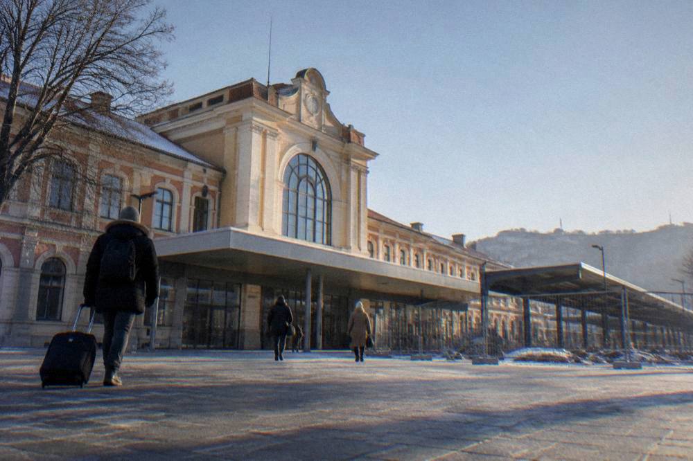Plovdiv central railway station facade on a cold clear morning with a few travellers on the forecourt