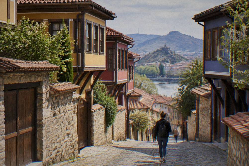 Traveller with a backpack walking along the pedestrian Main Street in Plovdiv