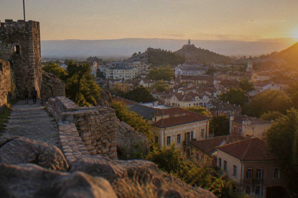 Evening view over the lit rooftops of Plovdiv Old Town from Nebet Tepe hill
