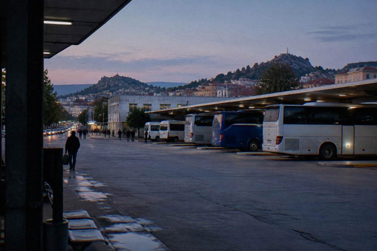 Long distance bus parked at a station platform in a Bulgarian city at dusk