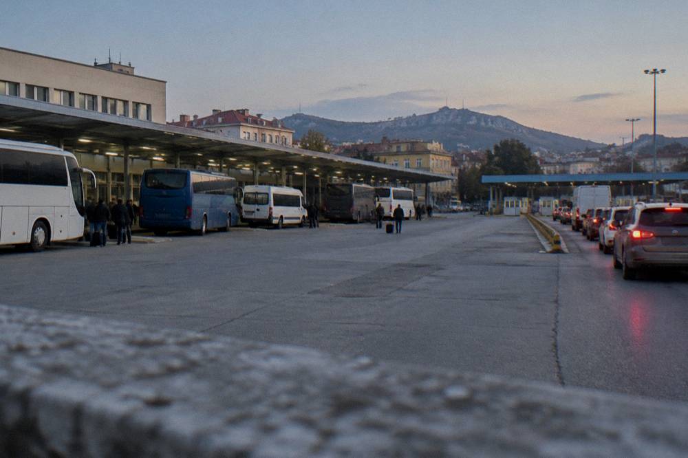 Border checkpoint booths with vehicles waiting in line at an international crossing