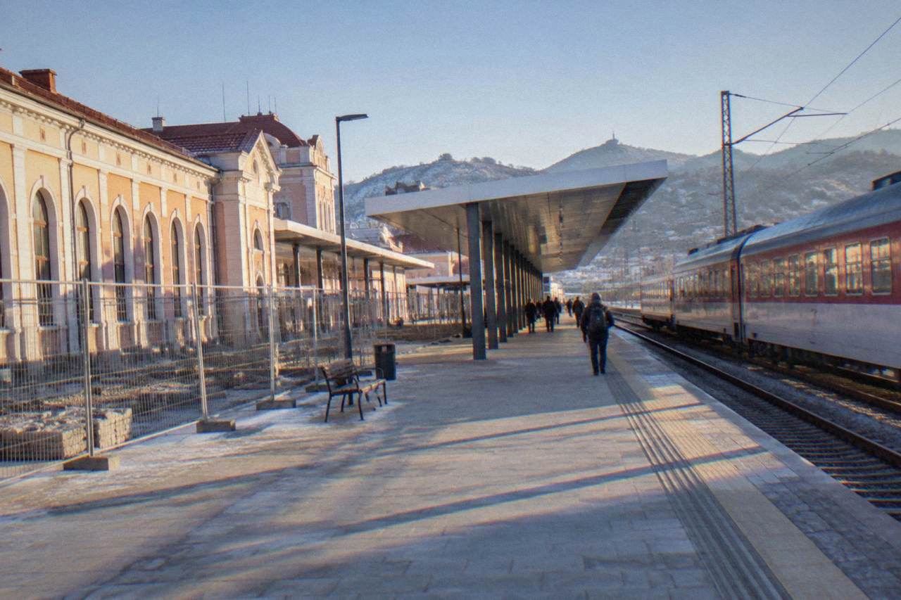 The platform area of Plovdiv Central railway station with a passenger train waiting beside a modernised canopy