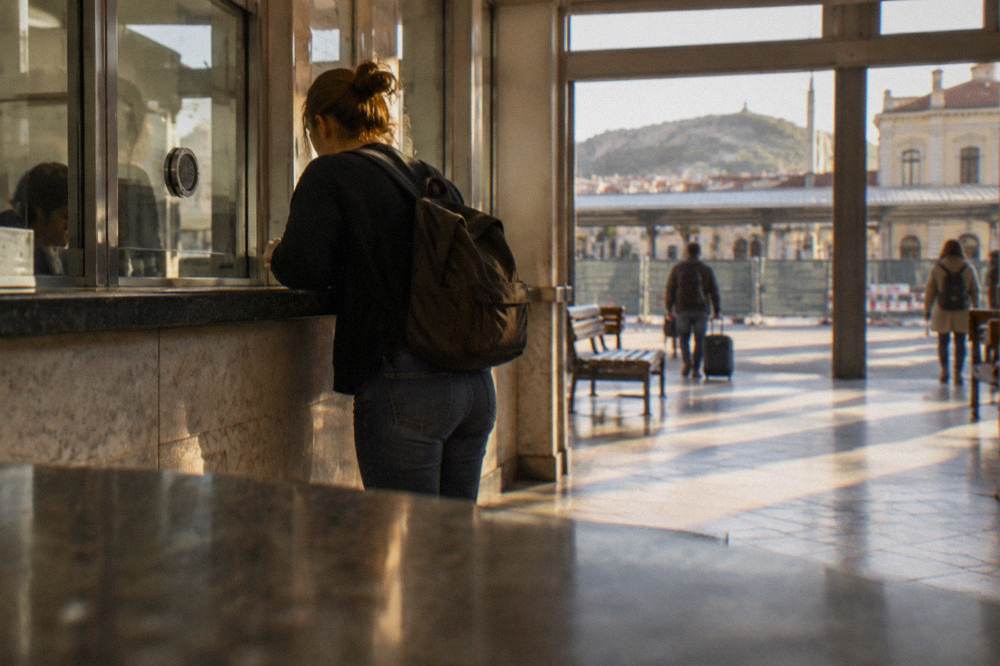 A traveller buying a train ticket at a counter inside Plovdiv Central railway station
