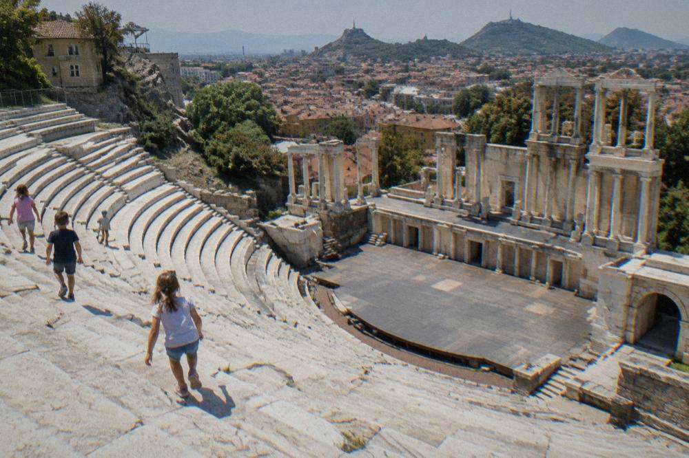 Children climbing the marble seating rows of the Ancient Theatre of Philippopolis in Plovdiv