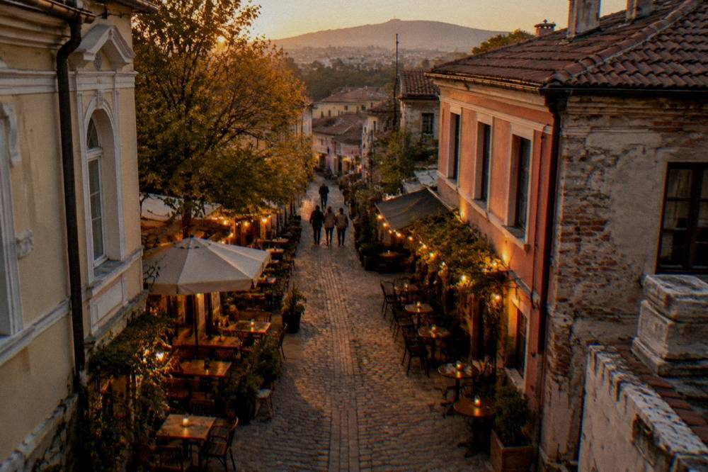 Evening in a narrow cobbled street of Kapana with small bars and outdoor tables lit by warm lights