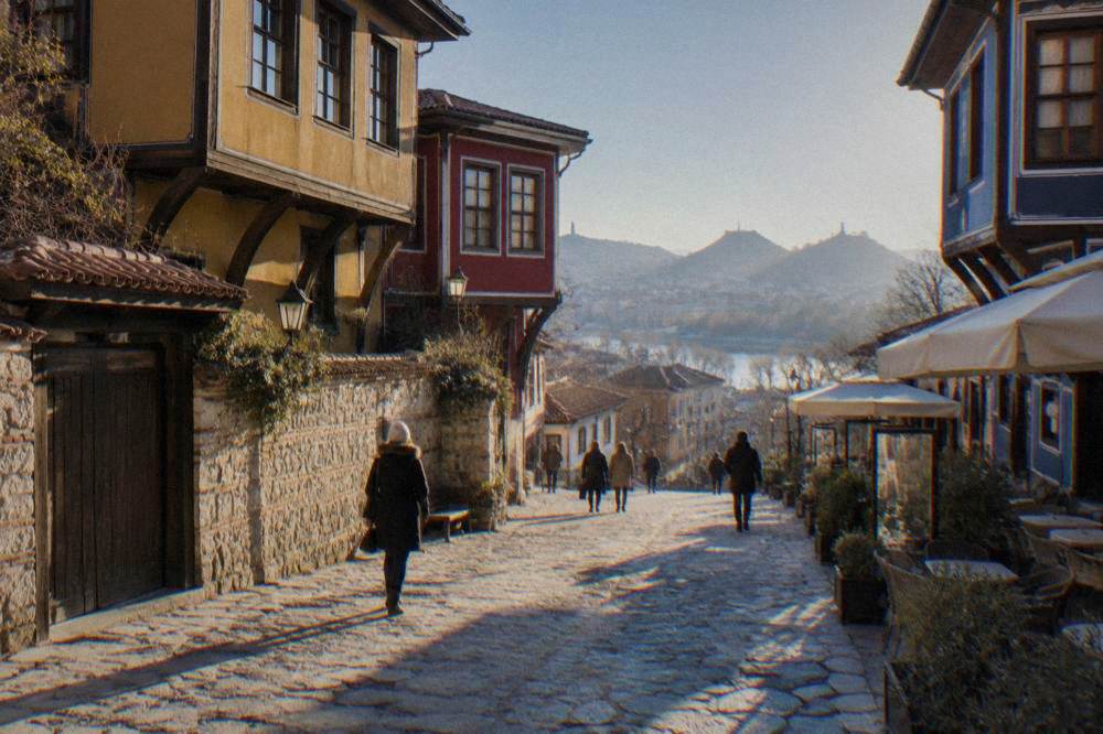 A wide pedestrian street in central Plovdiv lined with shops and cafe awnings