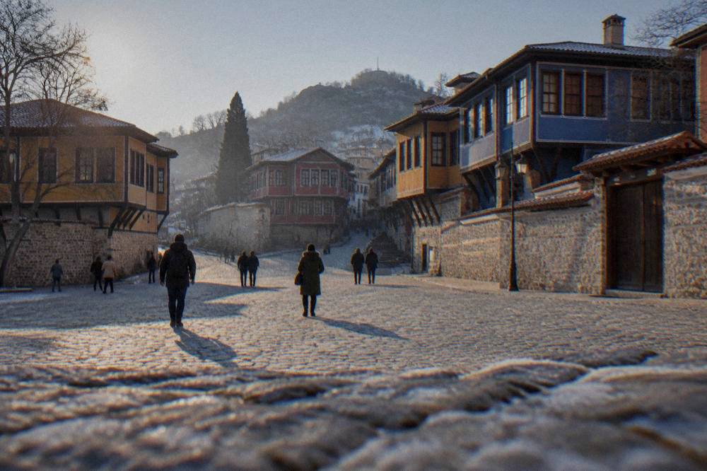 Pedestrians crossing the large central square between Main Street and the Old Town hills