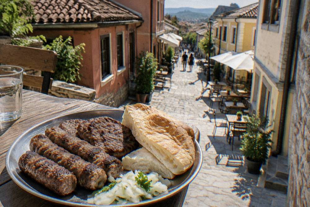 Grilled kebapche rolls and kyufte patties on a metal plate with bread