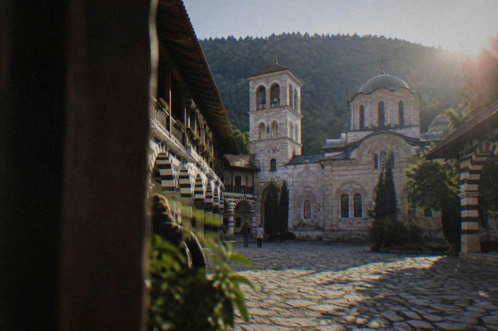 Bachkovo Monastery courtyard with its striped arcades and church tower