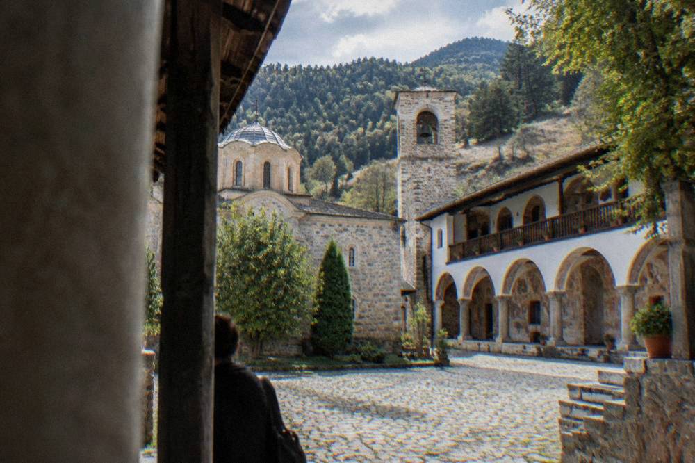 Bachkovo Monastery courtyard with arched walkways and frescoed walls