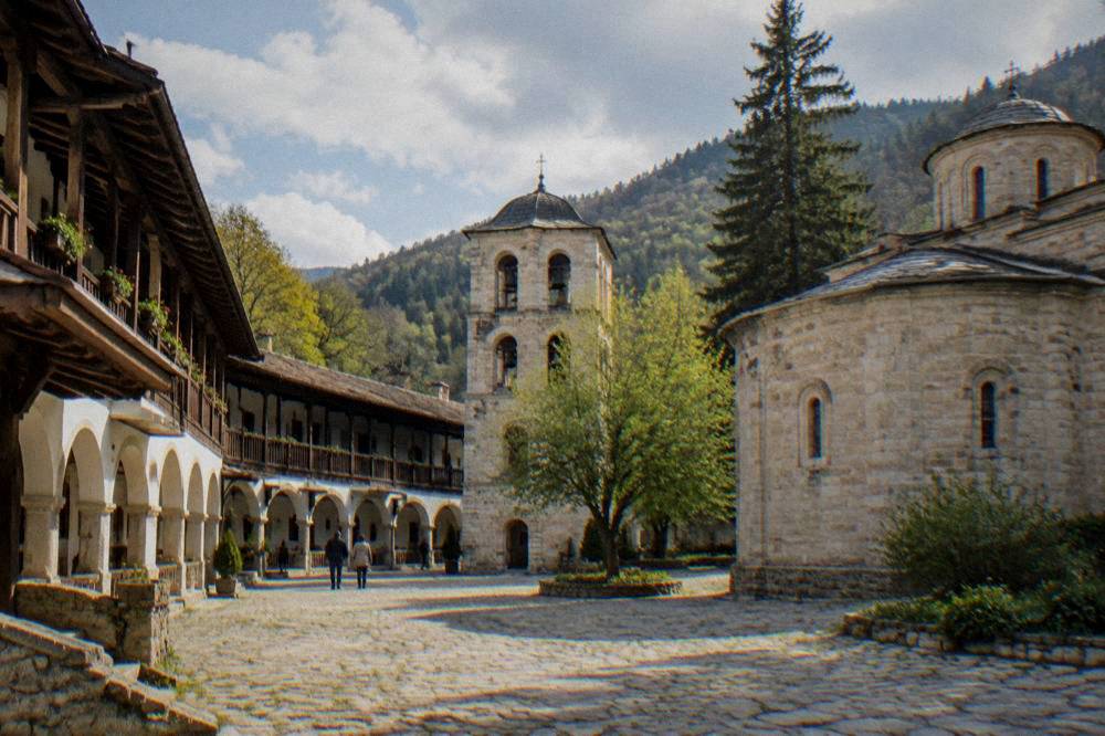Bachkovo Monastery courtyard with arched galleries and a bell tower