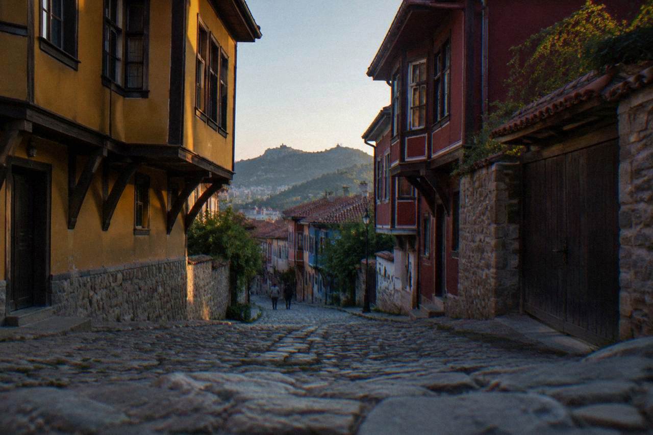 Cobbled street in Plovdiv Old Town with colourful Revival-era houses under a clear sky