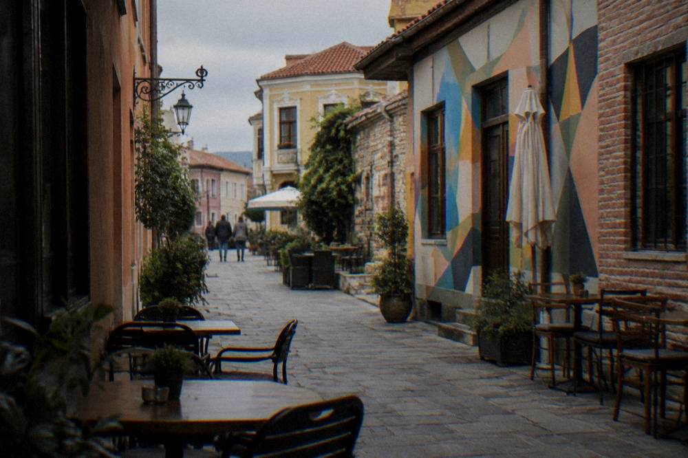 Narrow lane in the Kapana creative district of Plovdiv with painted murals and small shopfronts