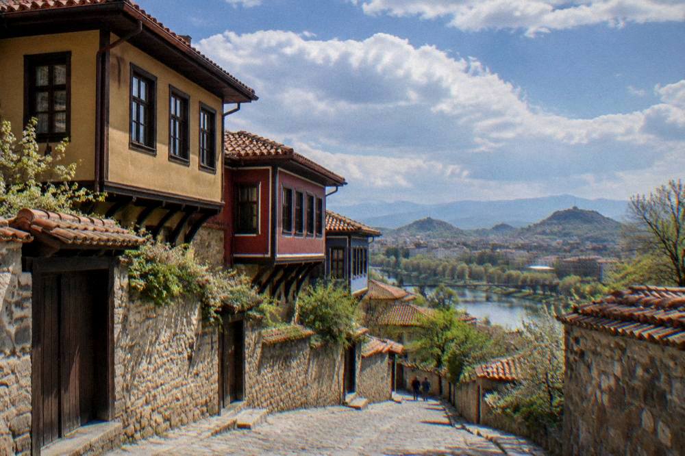 Country road winding through green hills toward the Rhodope Mountains south of Plovdiv