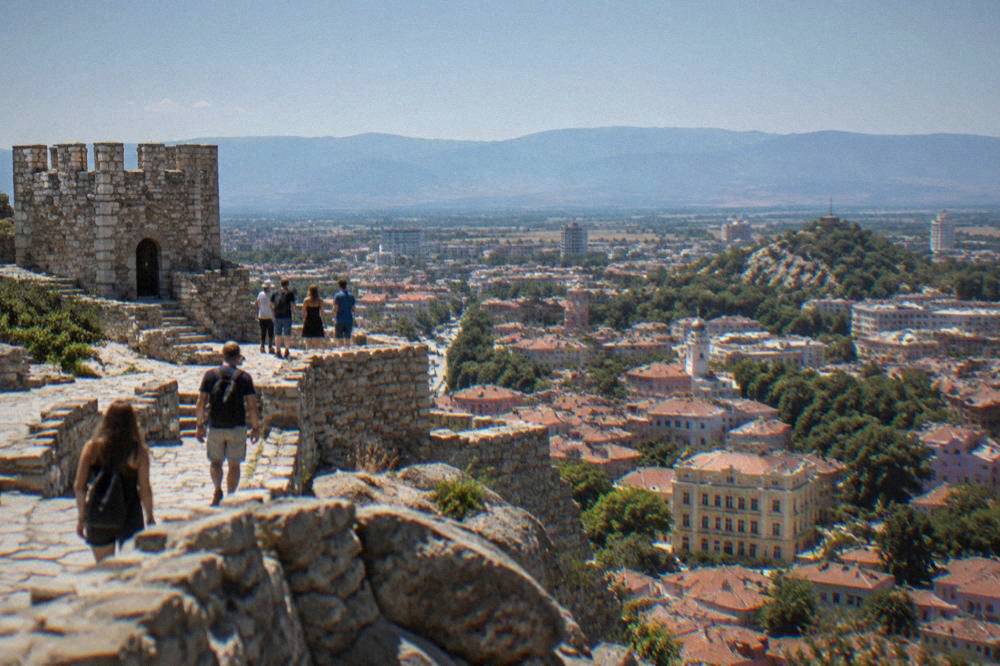 Visitors on the exposed summit of Nebet Tepe overlooking the city sprawl and distant mountains