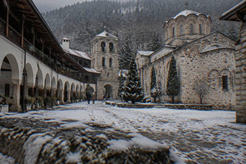 Bachkovo Monastery courtyard with arched galleries and a stone church