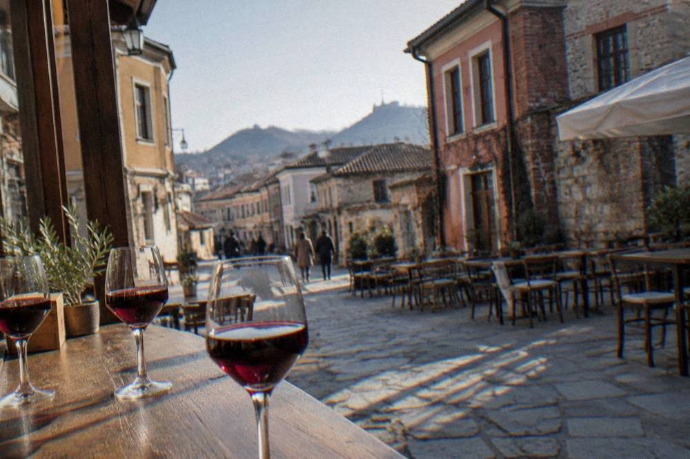 Glasses of red Bulgarian wine on a wooden tasting counter